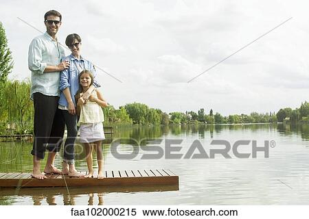 Stock Photography - "Family standing on dock, portrait". Fotosearch