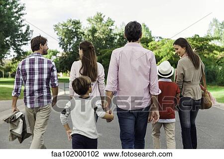 "Family walking together outdoors, rear view" View Large Photo Image Stock Image - "Family walking together outdoors, rear view". Fotosearch