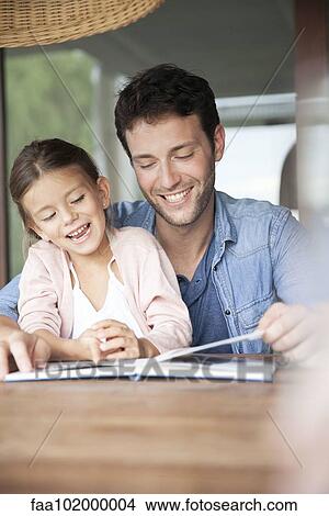 Father and daughter reading book together View Large Photo Image Picture - Father and daughter reading book together. Fotosearch