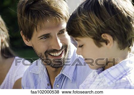 Stock Photo - Father and son talking together outdoors. Fotosearch