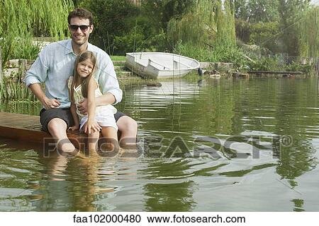 "Father and young daughter sitting on dock, portrait" View Large Photo Image Stock Image - "Father and young daughter sitting on dock, portrait". Fotosearch