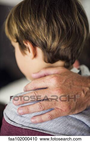 Stock Image - "Father's hand on little boy's shoulder, cropped". Fotosearch