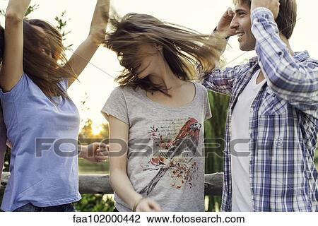 Friends partying together outdoors View Large Photo Image Stock Image - Friends partying together outdoors. Fotosearch