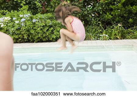 Stock Image - Girl doing cannonball into swimming pool. Fotosearch