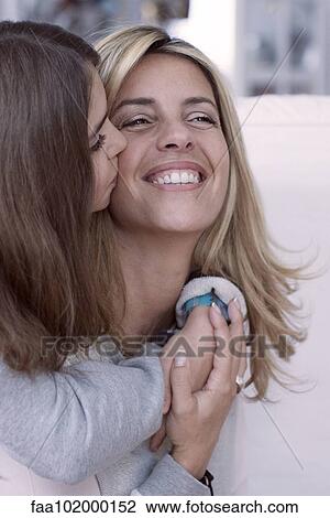 Girl kissing mother's cheek View Large Photo Image Stock Image - Girl kissing mother's cheek. Fotosearch