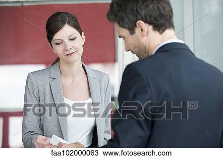 Hotel reception staff providing bill to guest View Large Photo Image Stock Image - Hotel reception staff providing bill to guest. Fotosearch