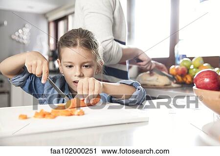 Little girl helping to prepare food in kitchen View Large Photo Image Stock Image - Little girl helping to prepare food in kitchen. Fotosearch