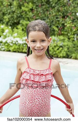 Picture - "Little girl playing in pool, portrait". Fotosearch