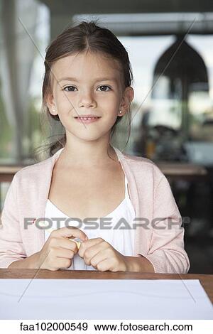 "Little girl sitting with pen and paper, portrait" View Large Photo Image Stock Photo - "Little girl sitting with pen and paper, portrait". Fotosearch