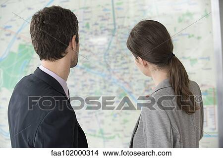 Picture - Man and woman looking at Paris metro map together. Fotosearch