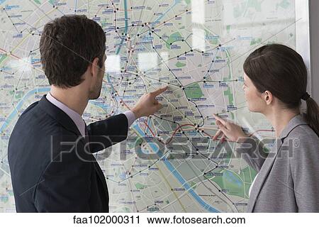 Man and woman looking at Paris metro map together View Large Photo Image Stock Image - Man and woman looking at Paris metro map together. Fotosearch