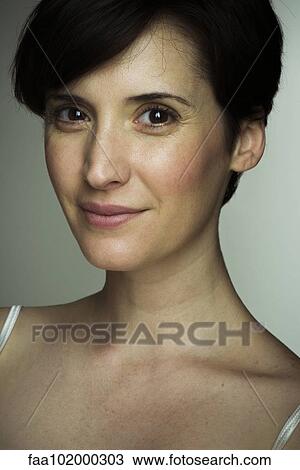 Stock Image - "Mid-adult woman, portrait". Fotosearch