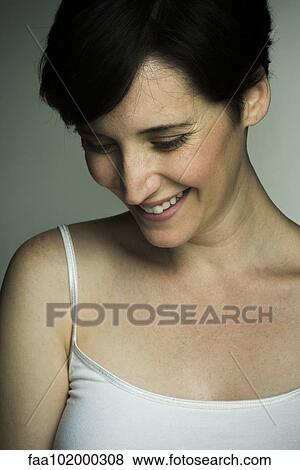 Stock Photo - "Mid-adult woman, portrait". Fotosearch