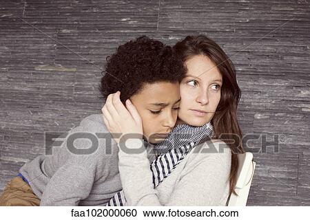 Mother and young son embracing View Large Photo Image Stock Image - Mother and young son embracing. Fotosearch