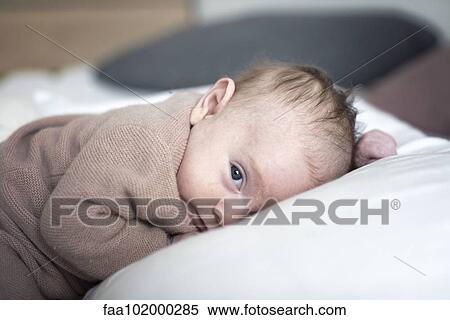 Stock Photography - "Newborn baby lying down, portrait". Fotosearch