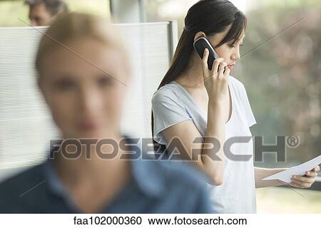 Office worker making phone call View Large Photo Image Stock Image - Office worker making phone call. Fotosearch
