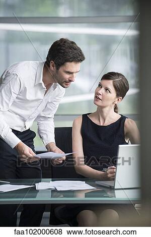 Office workers collaborating on project View Large Photo Image Stock Photo - Office workers collaborating on project. Fotosearch