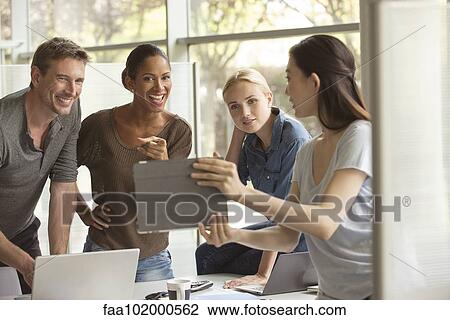 Office workers evaluating proposal View Large Photo Image Stock Image - Office workers evaluating proposal. Fotosearch