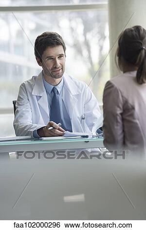 Patient listening as doctor explains test results View Large Photo Image Stock Photograph - Patient listening as doctor explains test results. Fotosearch