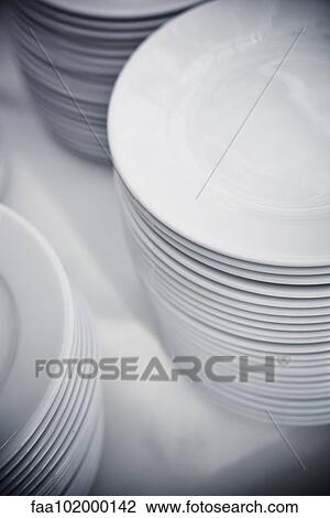 Plates stacked on table View Large Photo Image Stock Image - Plates stacked on table. Fotosearch