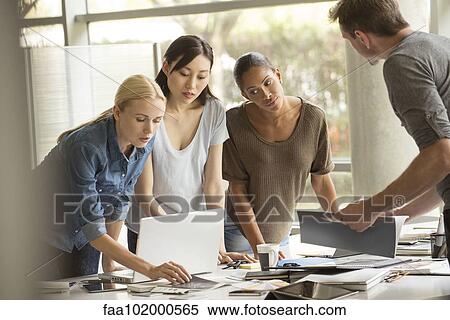 Stock Photography - Project team collaborating on project. Fotosearch