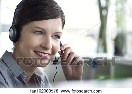 Receptionist using telephone headset View Large Photo Image Stock Photo - Receptionist using telephone headset. Fotosearch