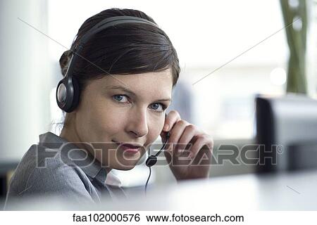 Stock Photograph - Receptionist using telephone headset. Fotosearch