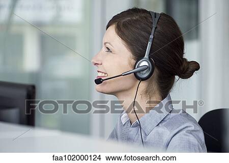 Picture - Receptionist wearing headset. Fotosearch