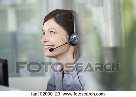 "Receptionist wearing headset, smiling cheerfully" View Large Photo Image Stock Image - "Receptionist wearing headset, smiling cheerfully". Fotosearch