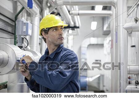 Skilled worker at work in industrial plant View Large Photo Image Stock Photo - Skilled worker at work in industrial plant. Fotosearch