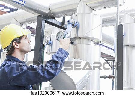 Skilled worker working on industrial equipment View Large Photo Image Stock Photo - Skilled worker working on industrial equipment. Fotosearch