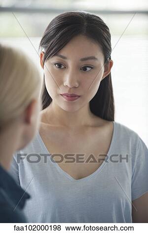 Woman having conversation with friend View Large Photo Image Stock Photo - Woman having conversation with friend. Fotosearch