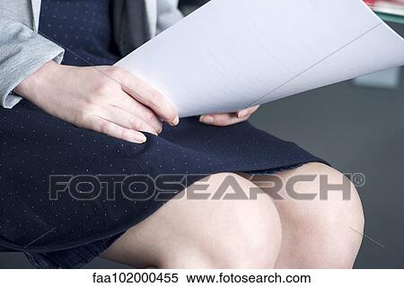 "Woman holding paperwork on lap, cropped" View Large Photo Image Stock Photography - "Woman holding paperwork on lap, cropped". Fotosearch
