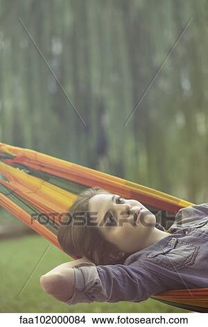 Woman relaxing in hammock View Large Photo Image Picture - Woman relaxing in hammock. Fotosearch