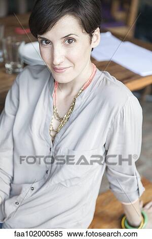 "Woman sitting and smiling, portrait" View Large Photo Image Stock Photography - "Woman sitting and smiling, portrait". Fotosearch