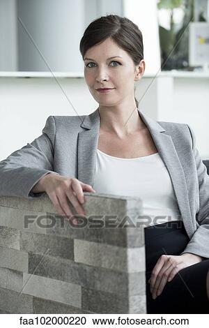 Woman sitting in waiting area View Large Photo Image Stock Image - Woman sitting in waiting area. Fotosearch