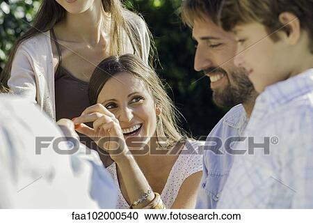 Woman spending time with her family outdoors View Large Photo Image Stock Image - Woman spending time with her family outdoors. Fotosearch