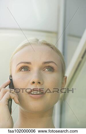 Stock Photograph - Woman talking on cell phone. Fotosearch