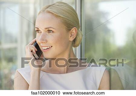 "Woman talking on smartphone, smiling" View Large Photo Image Stock Image - "Woman talking on smartphone, smiling". Fotosearch