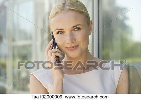 "Woman using cell phone, smiling, portrait" View Large Photo Image Stock Photo - "Woman using cell phone, smiling, portrait". Fotosearch