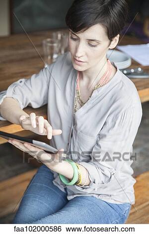 Woman using digital tablet View Large Photo Image Stock Photograph - Woman using digital tablet. Fotosearch