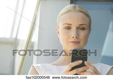 Woman using multimedia smartphone View Large Photo Image Stock Photograph - Woman using multimedia smartphone. Fotosearch