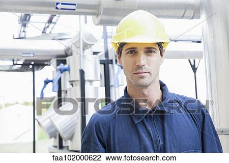 Stock Image - "Worker at industrial plant, portrait". Fotosearch