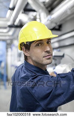 Worker at work in factory View Large Photo Image Stock Photo - Worker at work in factory. Fotosearch