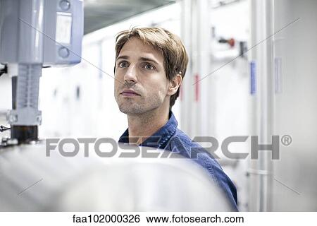 Worker at work in renewable energy production plant View Large Photo Image Stock Photograph - Worker at work in renewable energy production plant. Fotosearch