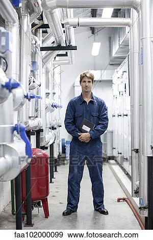 Stock Photo - "Worker in industrial plant, portrait". Fotosearch