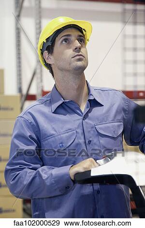 Worker working in warehouse View Large Photo Image Stock Photo - Worker working in warehouse. Fotosearch