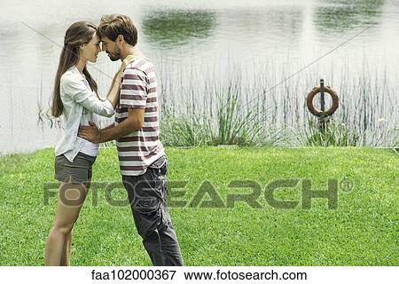 Stock Photo - Young couple embracing outdoors. Fotosearch