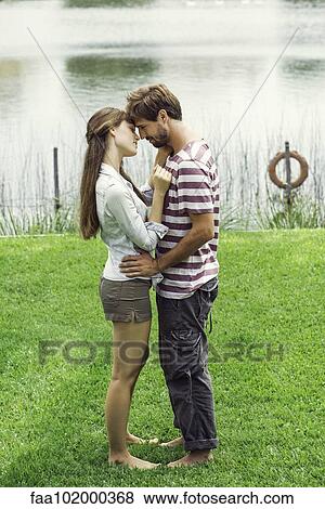 Stock Photo - Young couple embracing outdoors. Fotosearch
