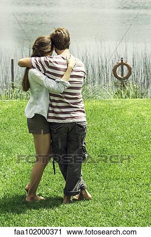 Young couple enjoying weekend holiday at lake View Large Photo Image Stock Image - Young couple enjoying weekend holiday at lake. Fotosearch